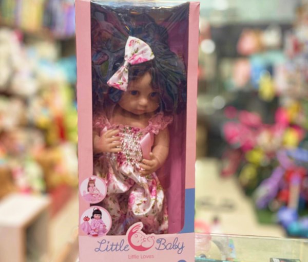 عروسک سیلیکونی دختر بچه 50 سانتی سخنگو با گل سر صورتی_اسباب بازی عروسک دخترانه